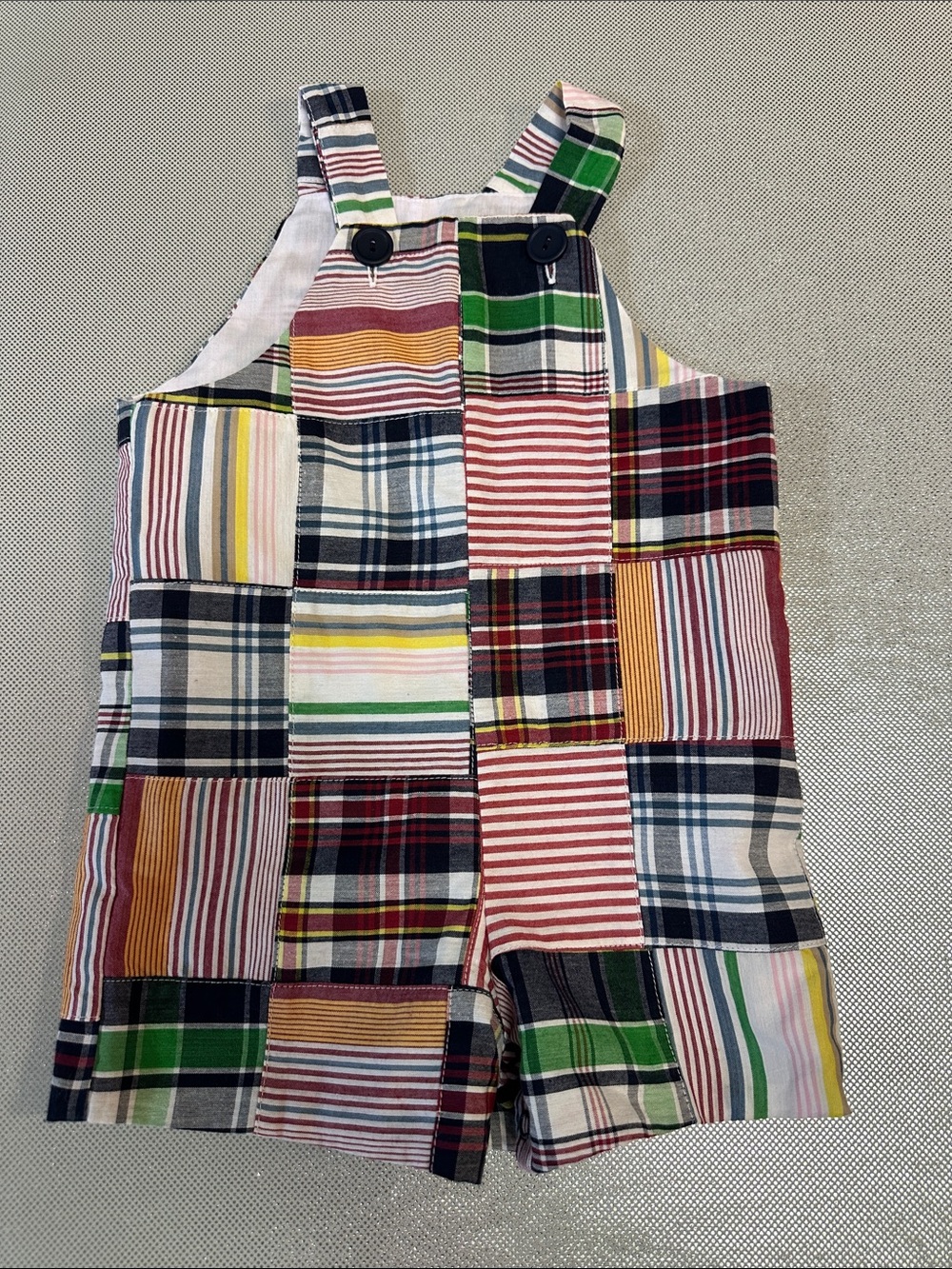 Kelly's Kids Infant short alls with different color patches throughout.